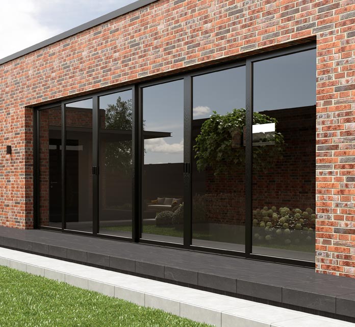 The exterior of a modern single-story extension with red brick walls and a wide span of black-framed floor-to-ceiling sliding glass doors.